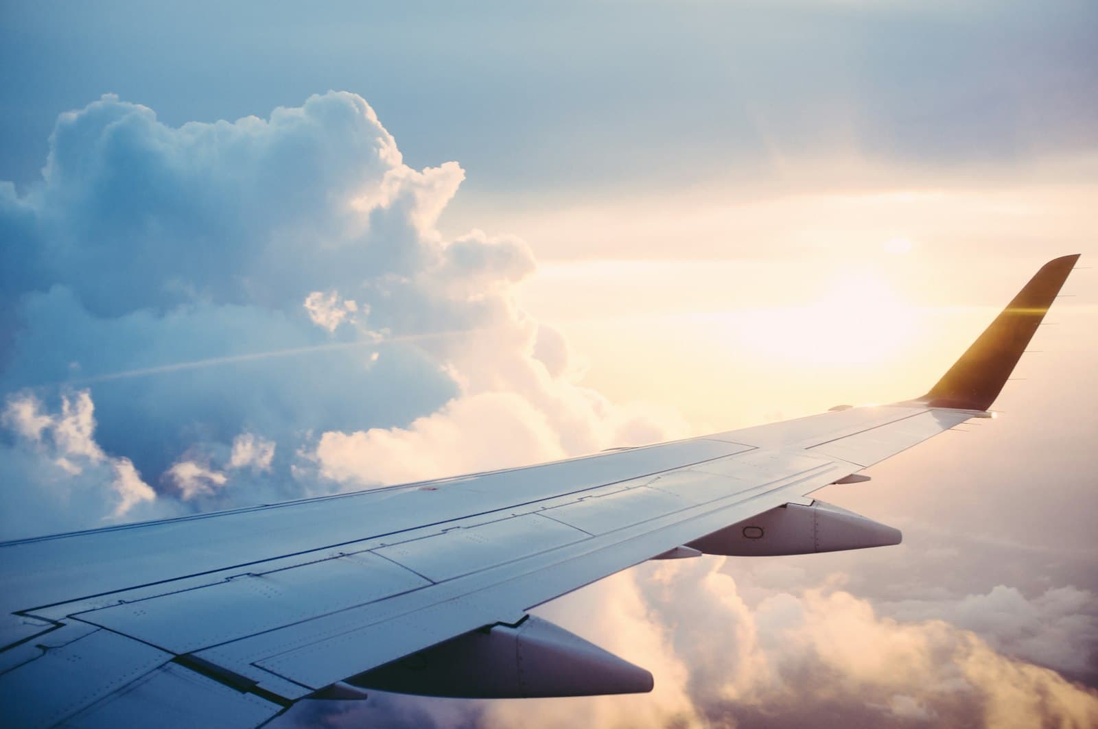 Airplane wing above a sea of clouds